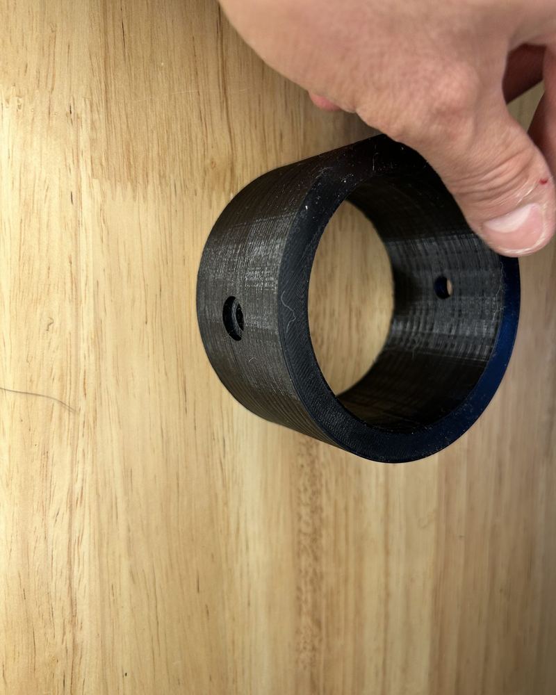3D-printed prototype ring held in hand